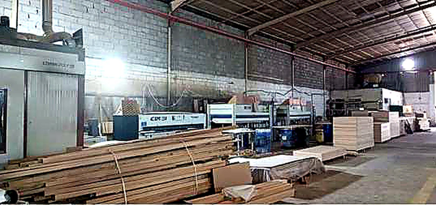 In-house carpentry workshop with timber storage and CNC machinery